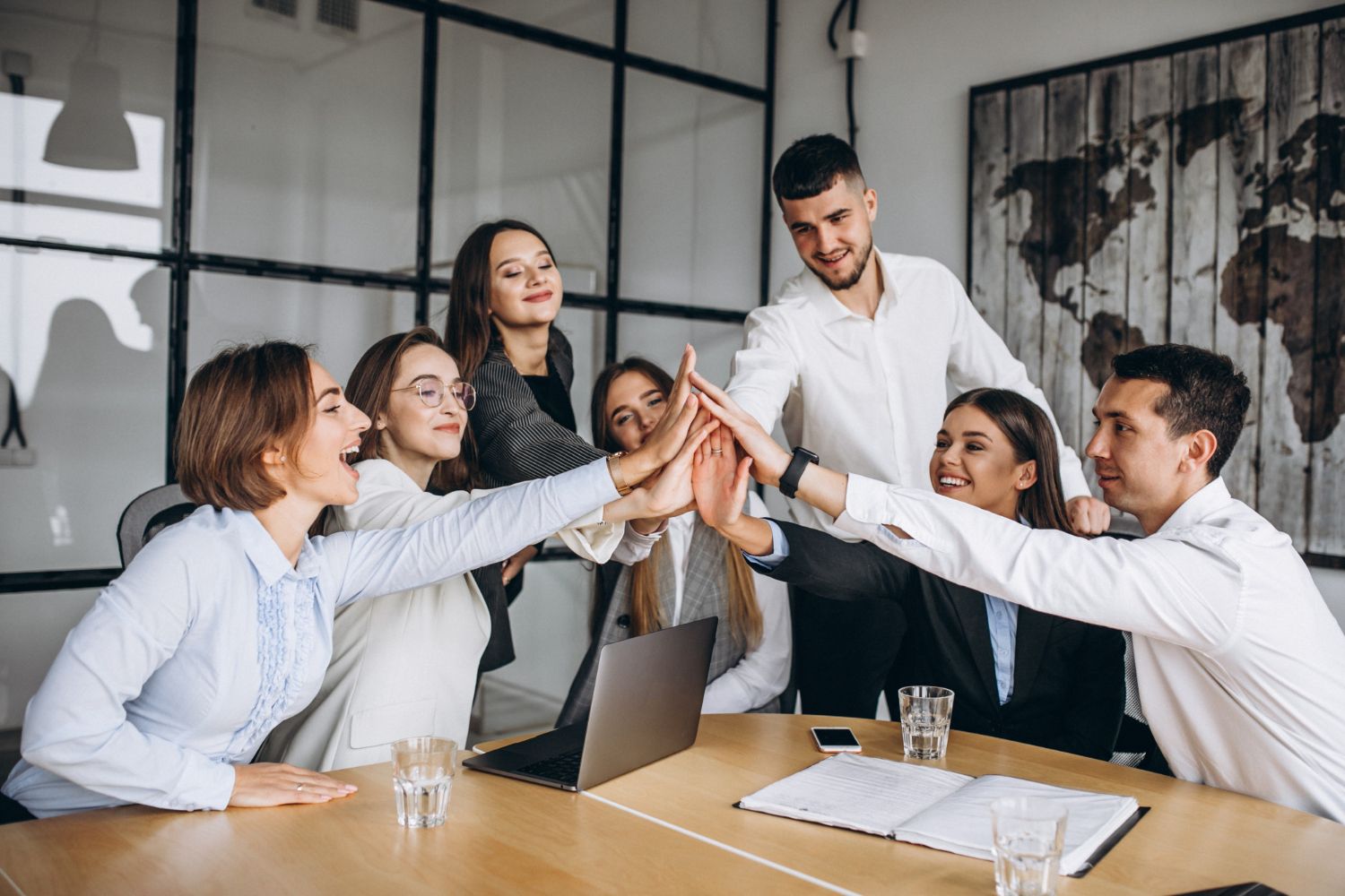 A team celebrating together around an office table